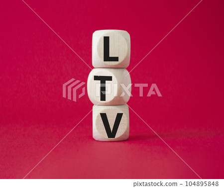 LTV - Life Time Value symbol. Concept word LTV on wooden cubes. Beautiful red background. Business and LTV concept. Copy space. 104895848
