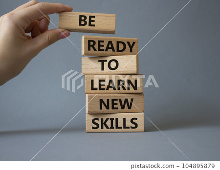 Learn new skills symbol. Concept words Be ready to Learn new skills on wooden blocks. Beautiful yellow background. Businessman hand. Business and Learn new skills concept. Copy space. Learn new skills symbol. Concept words Be ready to Learn new skills on wooden blocks. Beautiful yellow background. Businessman hand. Business and Learn new skills concept. Copy space. 104895879