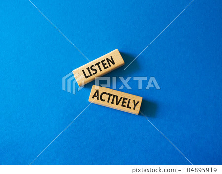 Listen actively symbol. Wooden blocks with words Listen actively. Beautiful blue background. Business and Active listening concept. Copy space. 104895919