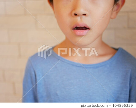 Front face of boy with open mouth Front face of boy with open mouth 104896339