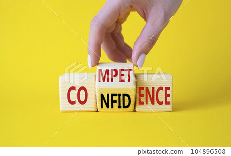Competence and Confidence symbol. Businessman hand turns wooden cubes and changes the words Confidence to Competence. Beautiful yellow background. Business concept. Copy space Competence and Confidence symbol. Businessman hand turns wooden cubes and changes the words Confidence to Competence. Beautiful yellow background. Business concept. Copy space 104896508