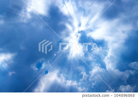 Sunbeam through the cloud on blue sky Sunbeam through the cloud on blue sky 104896868