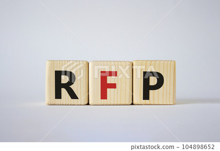 RFP - Request for Proposal. Wooden cubes with word RFP. Beautiful white background. Business and Request for Proposal concept. Copy space. 104898652