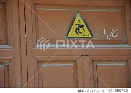 Electrical shock sign on a textured door in Alcala de Henares, Spain 104899710