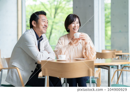 A couple drinking coffee and having a conversation in a cafe A couple drinking coffee and having a conversation in a cafe 104900929