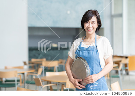 Middle-aged female clerk working in a cafe Middle-aged female clerk working in a cafe 104900959