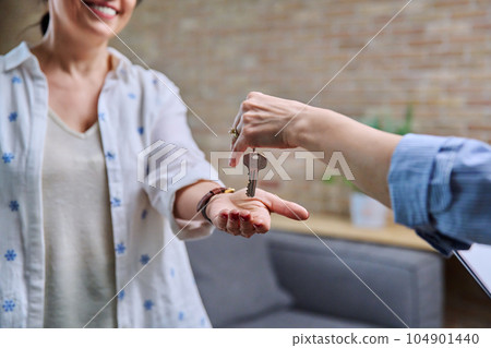 Mature woman buyer real estate tenant taking keys from realtor hands Mature woman buyer real estate tenant taking keys from realtor hands 104901440