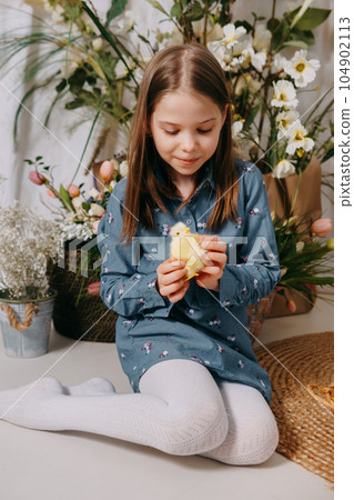 Two girls in a beautiful Easter photo zone with flowers, eggs, chickens and Easter bunnies. Happy Easter holiday. Two girls in a beautiful Easter photo zone with flowers, eggs, chickens and Easter bunnies. Happy Easter holiday. 104902113