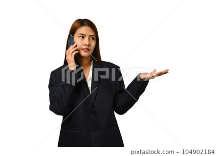 Beautiful young businesswoman in black suit talking on mobile phone and presenting at empty space isolated on white background 104902184