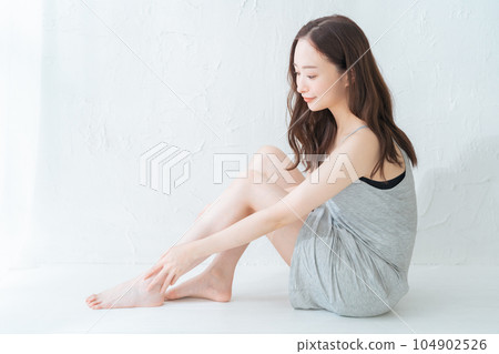 Young woman doing leg skin care and massage Young woman doing leg skin care and massage 104902526