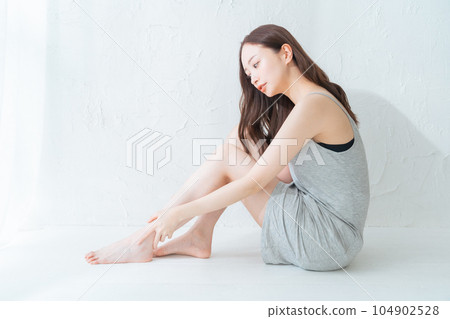 Young woman doing leg skin care and massage Young woman doing leg skin care and massage 104902528