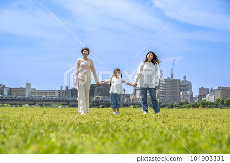 Grandmothers, moms and children taking a walk holding hands Grandmothers, moms and children taking a walk holding hands 104903331