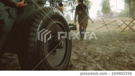 Preparing For Historical Reenactment. Group Of Re-enactors Dressed As Russian Soviet Red Army Infantry Soldiers Of World War Ii Are Move Soviet 45mm Anti-tank Gun To Combat Position 104903356