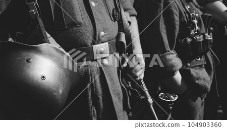Close-up View On Re-enactor Dressed As German Wehrmacht Infantry Soldier In World War Ii. German Soldier Uniform. German Soldier's Outfit. Black And White 104903360