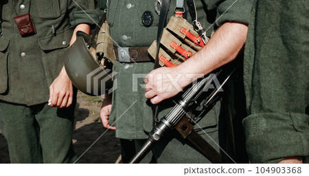 Re-enactor Dressed As German Wehrmacht Infantry Soldier In World War Ii With Submachine Gun Mp 40. German Soldier Uniform. German Soldier's Outfit 104903368