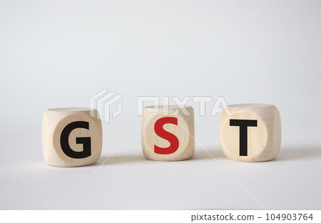 GST - Goods and Services Tax symbol. Concept word GST on wooden cubes. Beautiful white background. Business and GST concept. Copy space. GST - Goods and Services Tax symbol. Concept word GST on wooden cubes. Beautiful white background. Business and GST concept. Copy space. 104903764