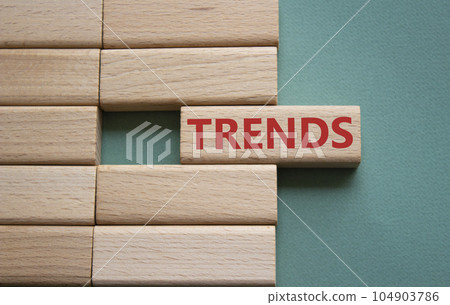 Trends symbol. Concept word Trends on wooden blocks. Beautiful grey green background. Business and Trends concept. Copy space. 104903786