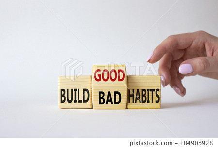 Build Good or Bad Habits symbol. Businessman hand points at wooden cubes with words Build Bad Habits vs Build good Habits. Beautiful white background. Business concept. Copy space 104903928