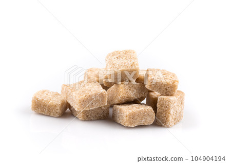 Heap brown sugar cubes isolated Heap brown sugar cubes isolated 104904194
