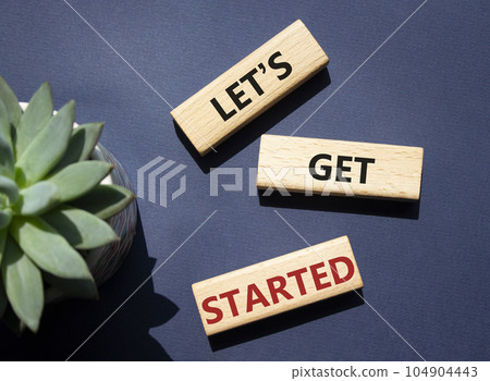 Lets get started symbol. Concept words Lets get started on wooden blocks. Beautiful deep blue background. Business and Lets get started concept. Copy space. 104904443