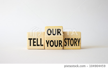 Tell Your or Our story symbol. Wooden cubes with words Tell Our story and Tell Your story. Beautiful white background. Business concept. Copy space 104904459