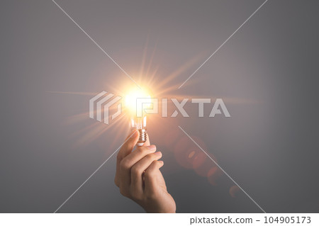 Business man holding light bulb. New idea, innovation technology and creative concept. Business man holding light bulb. New idea, innovation technology and creative concept. 104905173