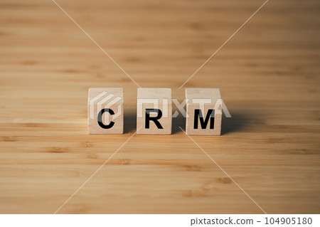 CRM Customer Relationship Management wooden cube block on wooden table. business strategy and marketing  concept 104905180