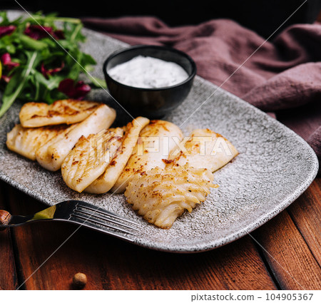 Fried white fish fillet with arugula Fried white fish fillet with arugula 104905367