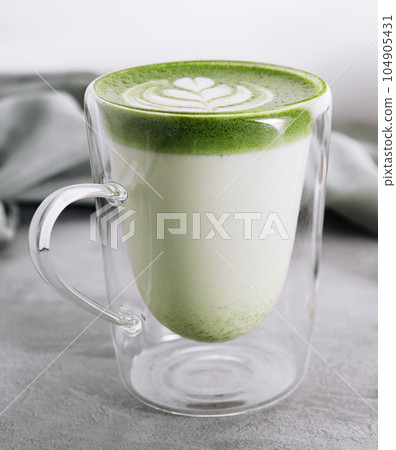 Green matcha latte with pistachios close up Green matcha latte with pistachios close up 104905431