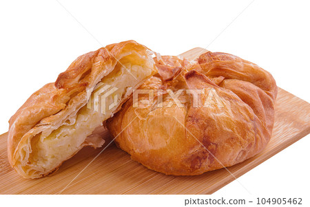 Baking puff pastry vertuta with potatoes on wooden 104905462