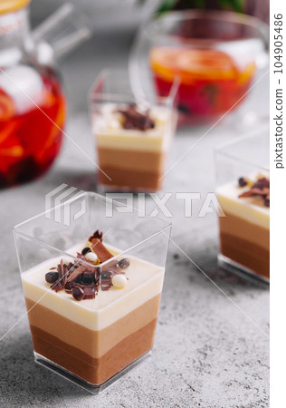 Layered dessert Trifles in a transparent glasses 104905486