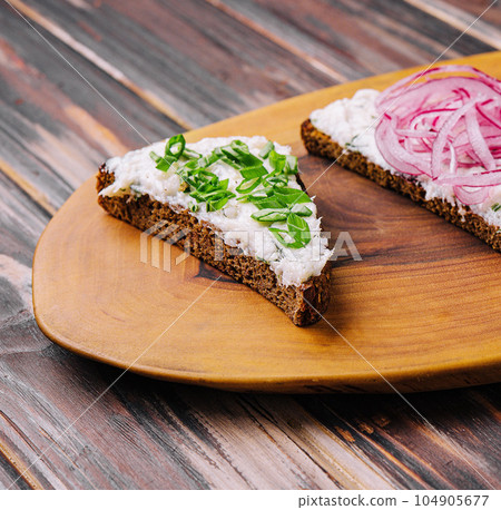 pieces of bread with delicious lard with red and green onions 104905677