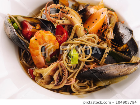 Seafood pasta spaghetti with prawns, squis, mussel and tomatoes Seafood pasta spaghetti with prawns, squis, mussel and tomatoes 104905784