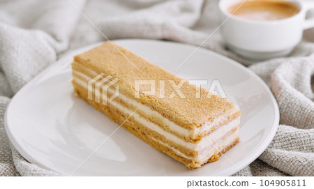 Napoleon cake slices with cup of coffee Napoleon cake slices with cup of coffee 104905811