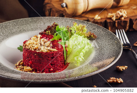 Warm beetroot, nuts and herbs salad Warm beetroot, nuts and herbs salad 104905882