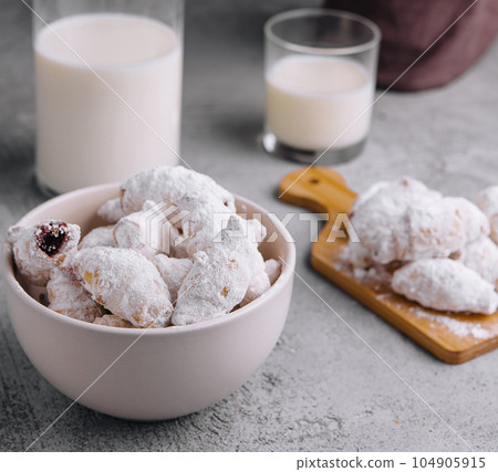 Homemade cookies twisted, sprinkled with powdered sugar Homemade cookies twisted, sprinkled with powdered sugar 104905915