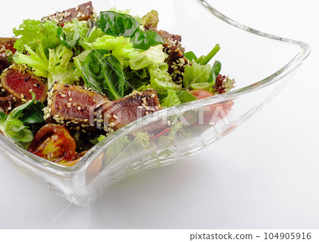 Salad with fried tuna on glass plate Salad with fried tuna on glass plate 104905916