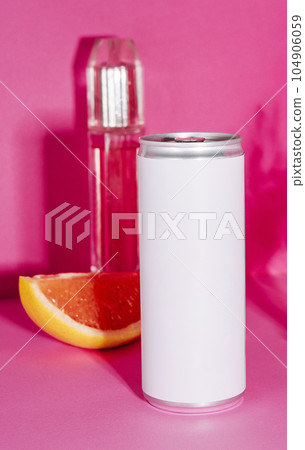 soda in a tin and perfume on a pink background 104906059