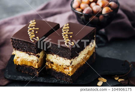 Fluffy snickers cake on stone board 104906175