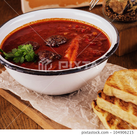 Traditional mexican red pozole soup in bowl Traditional mexican red pozole soup in bowl 104906215
