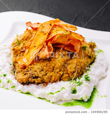 rice with meat in batter and carrot chips 104906299