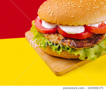 Burgers with cutlet, tomato and lettuce Burgers with cutlet, tomato and lettuce 104906375