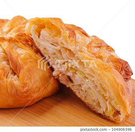 Baking puff pastry with fresh cabbage on wooden 104906396