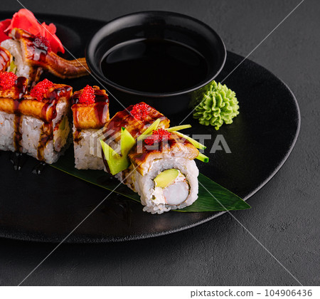 Canada roll with snow crab on black plate Canada roll with snow crab on black plate 104906436