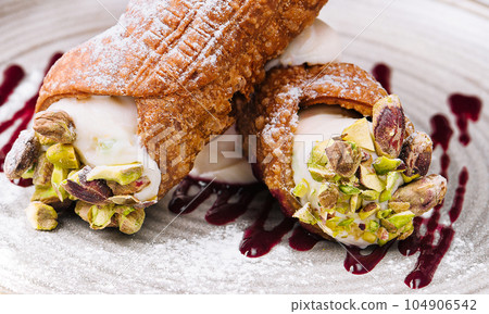Traditional italian dessert cannoli siciliani on plate Traditional italian dessert cannoli siciliani on plate 104906542