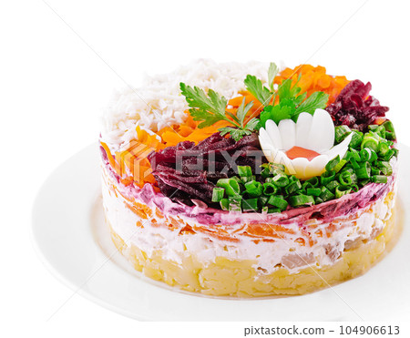 Layered salad with beet, herring, carrots and potatoes on plate 104906613