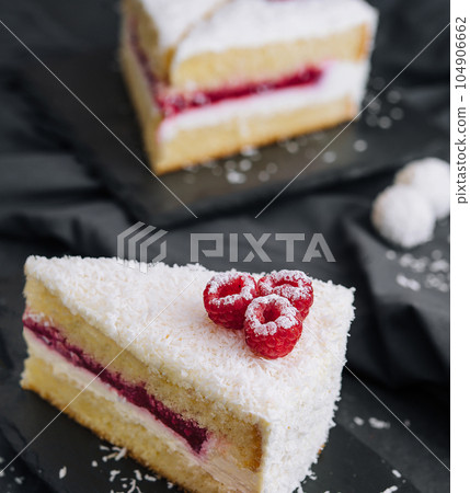 Winter cake with white cream decorated raspberries 104906662