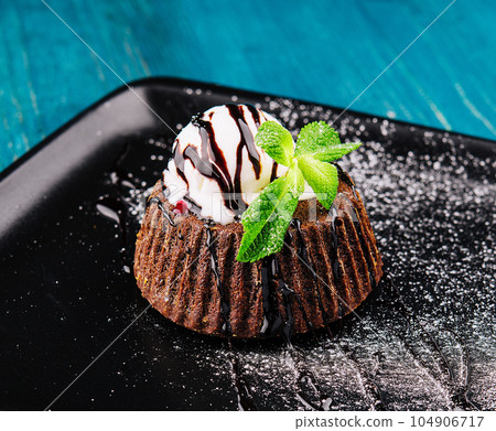 Chocolate brownie with vanilla ice cream 104906717