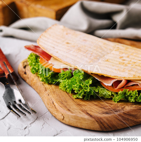 Lavash sandwich with prosciutto and cheese 104906950