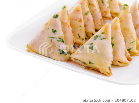 triangular pancakes with meat on plate triangular pancakes with meat on plate 104907108